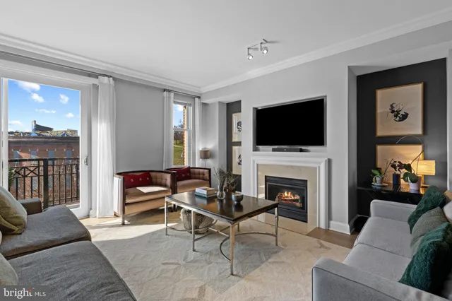 a living room with furniture a fireplace and a flat screen tv
