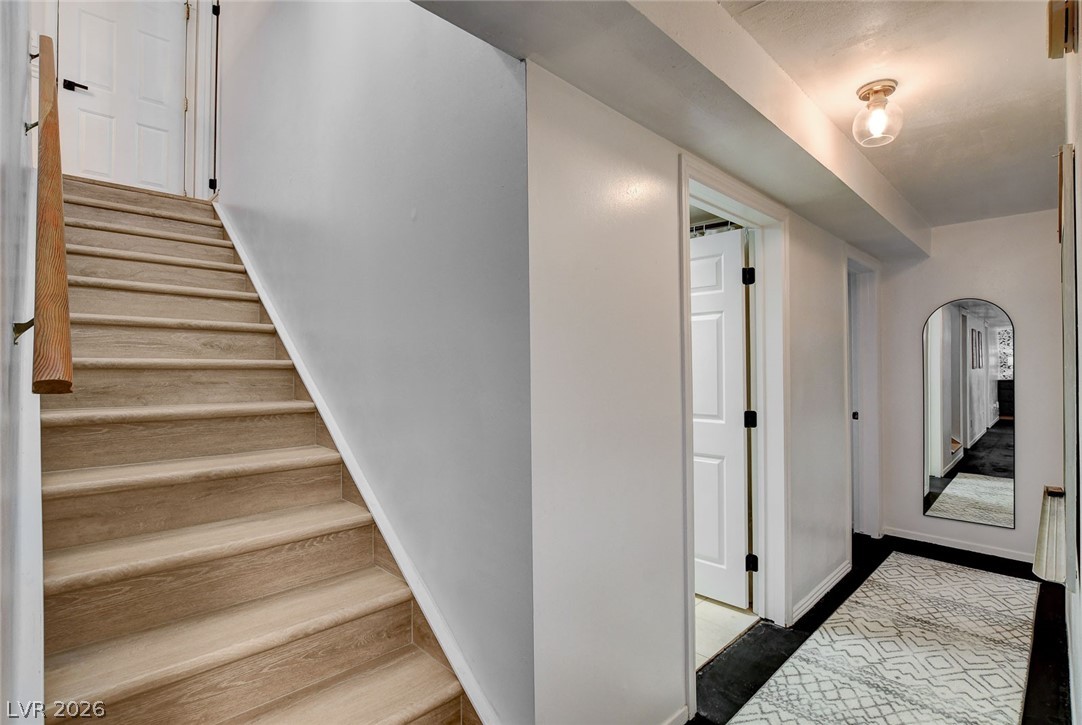 3765 Berkeley Street Logandale, NV 89021 - Photo 47 of 87 This interior hallway features a staircase leading up to an additional level.