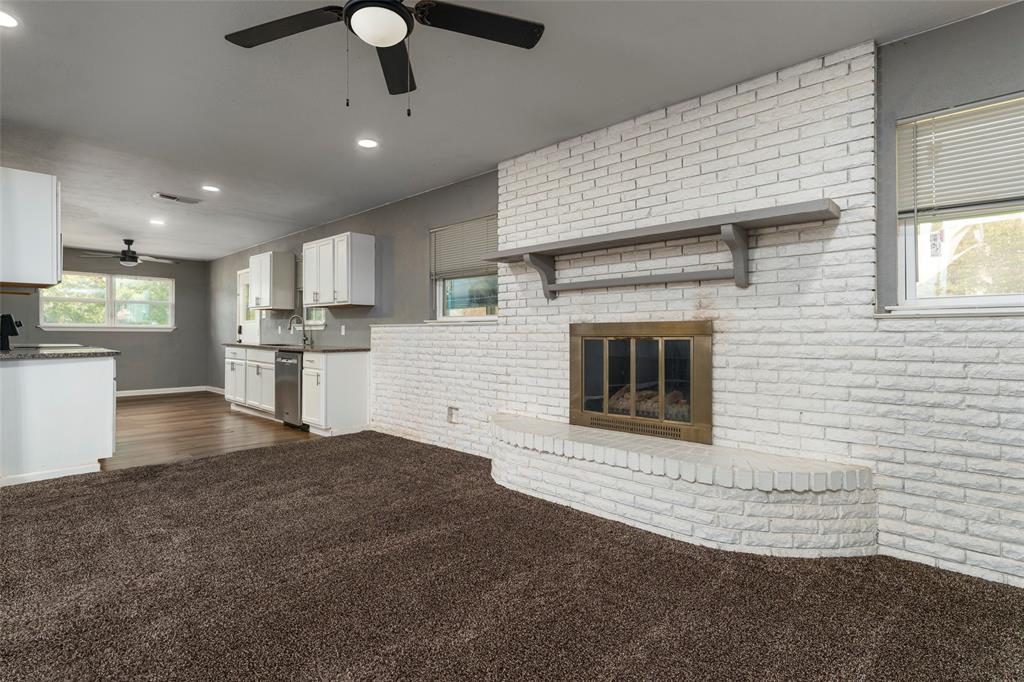 1101 Kennedale Sublett Road Kennedale, TX 76060 - Photo 11 of 35 White painted brick fireplace, wood-finish flooring, white cabinetry, recessed lighting, and ceiling fans