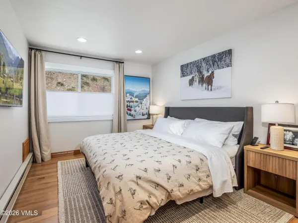 a bedroom with a bed and a night stand