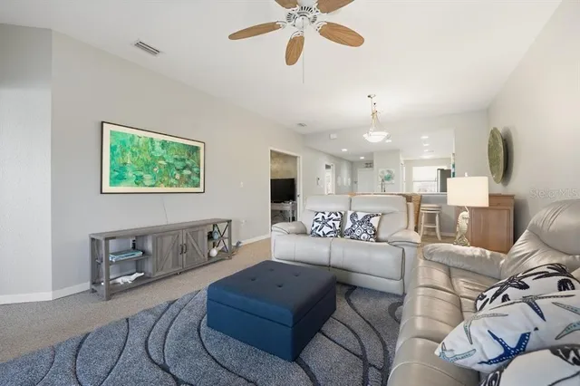 a spacious bedroom with a bed and a chandelier