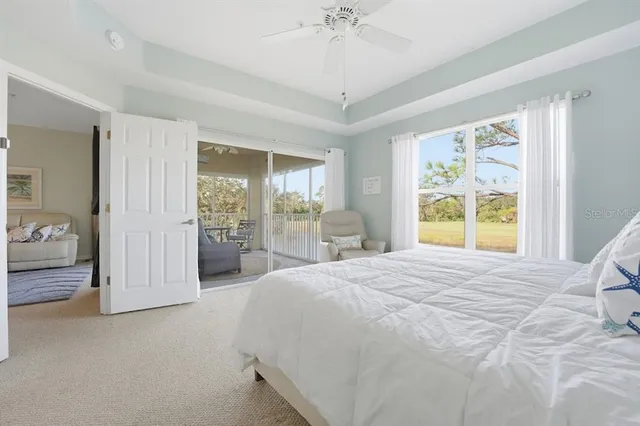 a spacious bedroom with a balcony a large bed and a large mirror