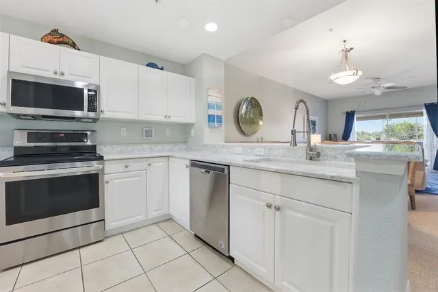 a kitchen with a refrigerator and a stove