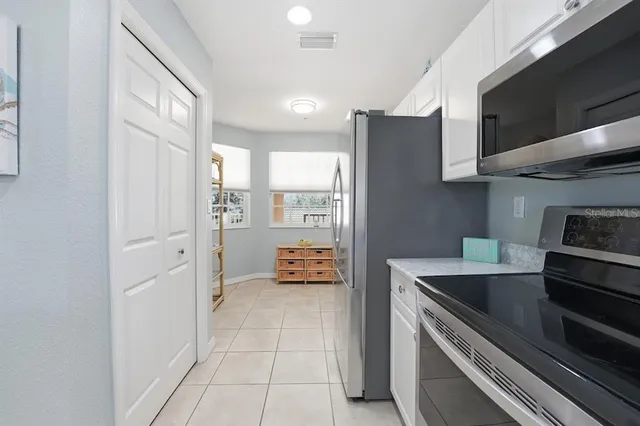 a kitchen with stainless steel appliances a refrigerator sink and cabinets