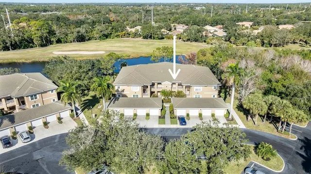 an aerial view of a house with outdoor space and lake view