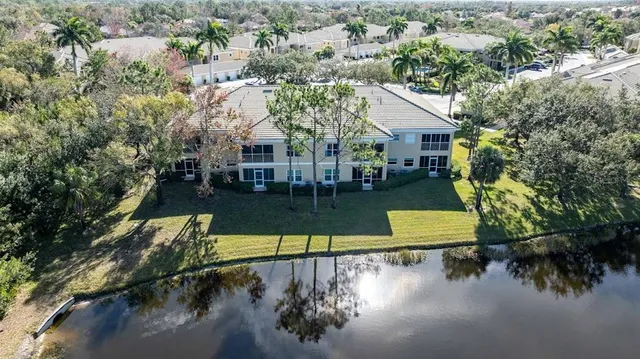 an aerial view of residential houses with outdoor space and trees