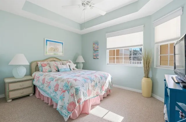 a bedroom with a bed and a lamp on dresser