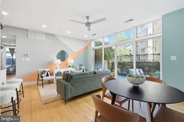 a living room with furniture and a potted plant