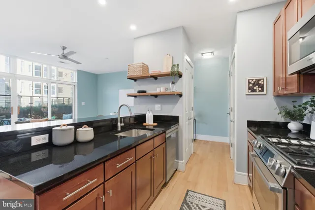 a kitchen with a sink stove and cabinets