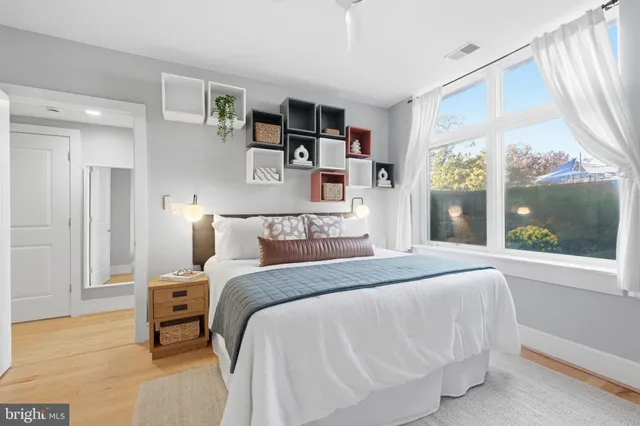 a bedroom with a bed and a large window with outer view