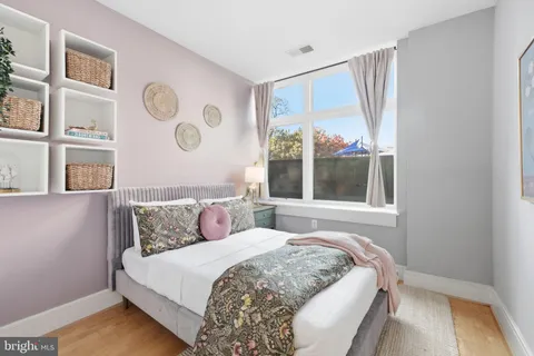 a bedroom with a large bed and a large window