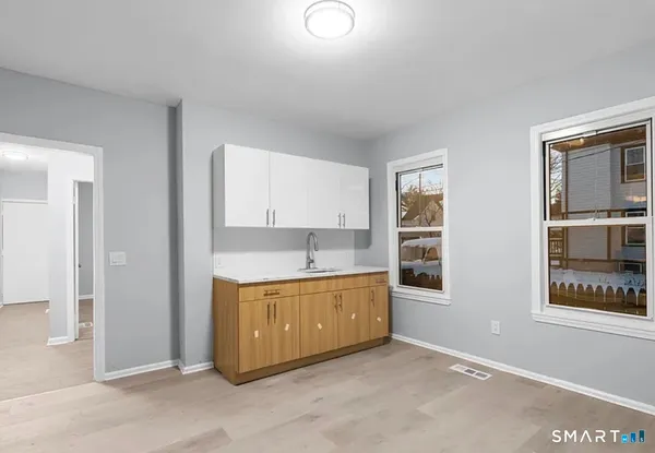 a large kitchen with stainless steel appliances granite countertop a stove and a refrigerator
