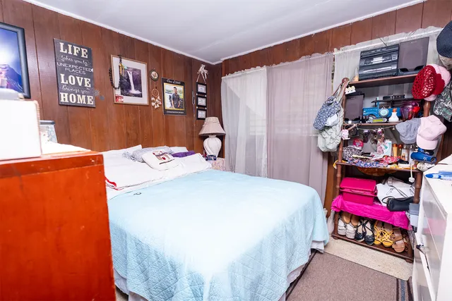 a bedroom with a bed and a window