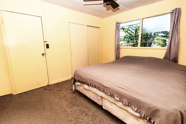 a bed sitting in a room next to a window