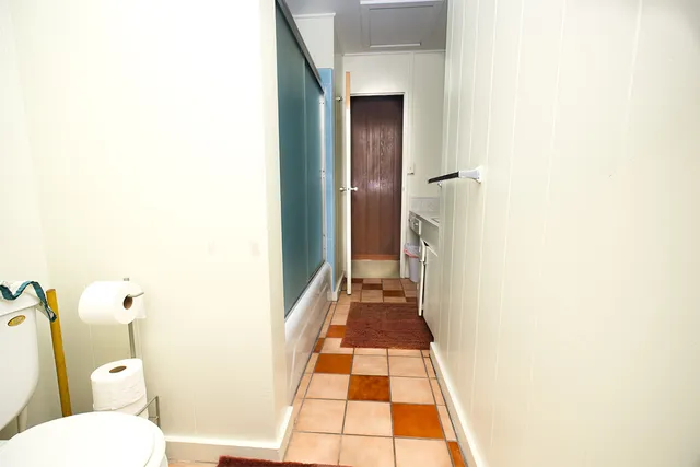 a bathroom with a toilet and a shower