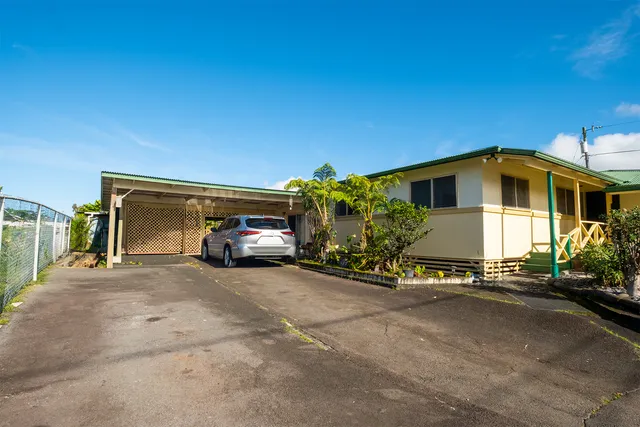 a view of a car park in front of house
