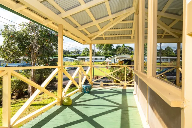 a view of a swimming pool with a large window and sitting area
