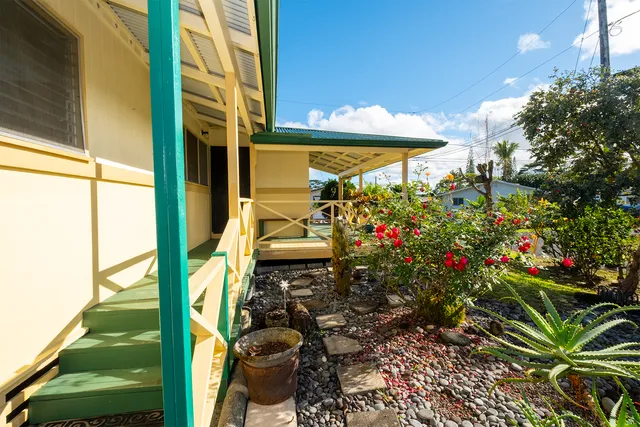 a view of a porch with a flower garden