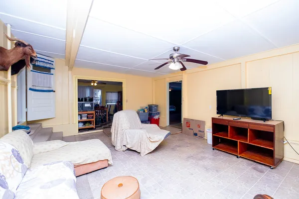 a bedroom with furniture and a flat screen tv