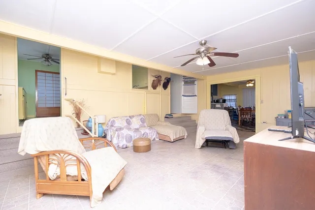 a living room with furniture and a lamp
