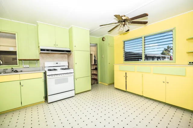 a kitchen with a stove a sink and a refrigerator