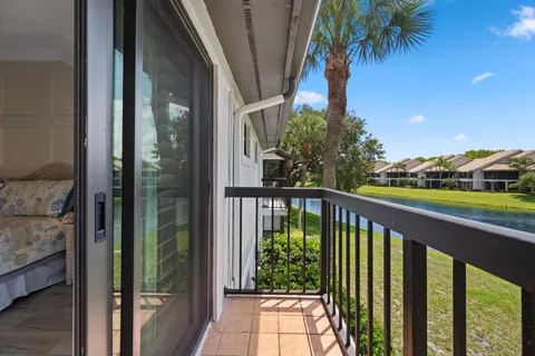 a view of a balcony with a yard