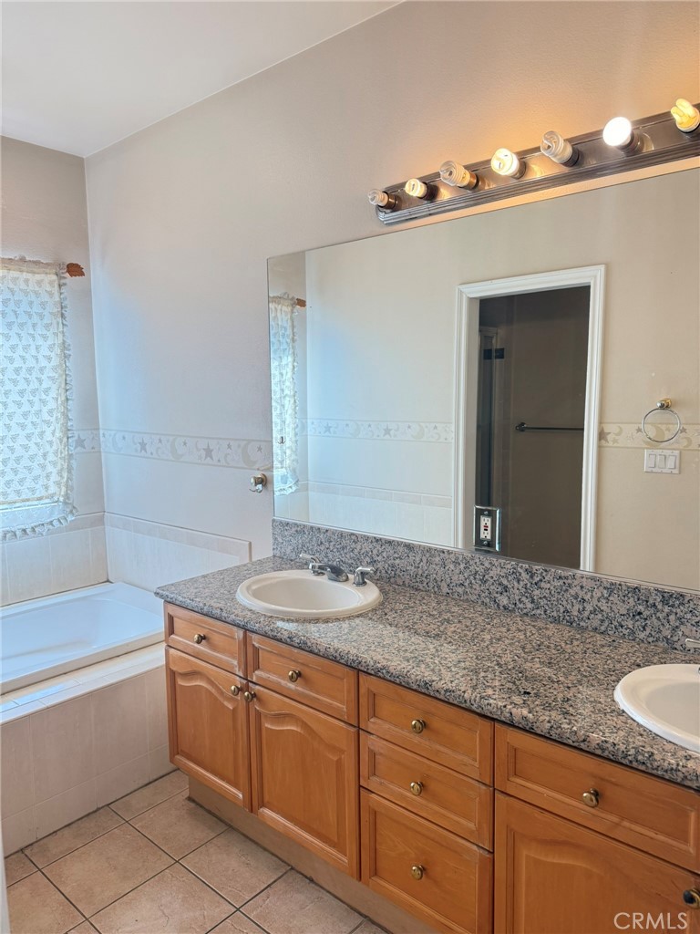 929 West Duarte Road, Unit B Arcadia, CA 91007 - Photo 7 of 11 a bathroom with a granite countertop sink mirror and bathtub