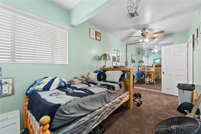 a bedroom with bed and a chandelier