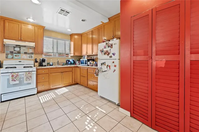 a kitchen with stainless steel appliances granite countertop a stove sink and cabinets