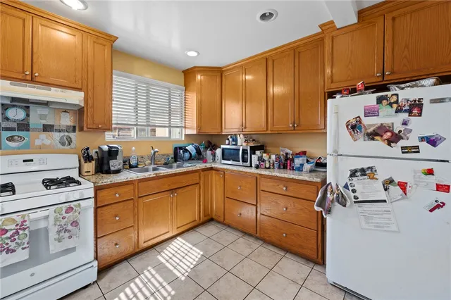 a kitchen with cabinets appliances and a window