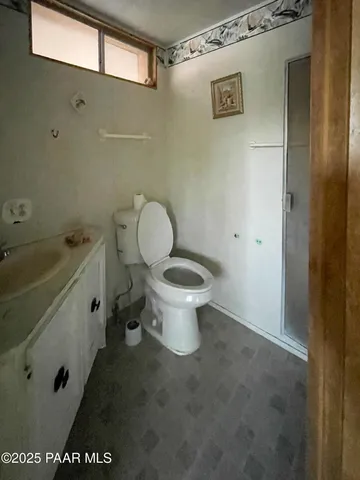 a white toilet sitting next to a bathroom sink