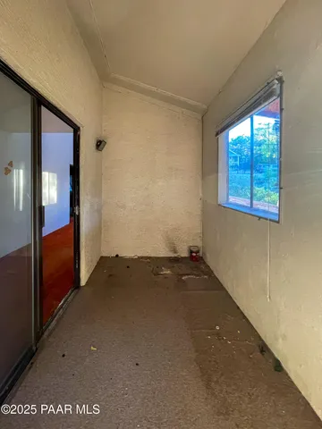 a view of a wooden house with a yard and wooden fence