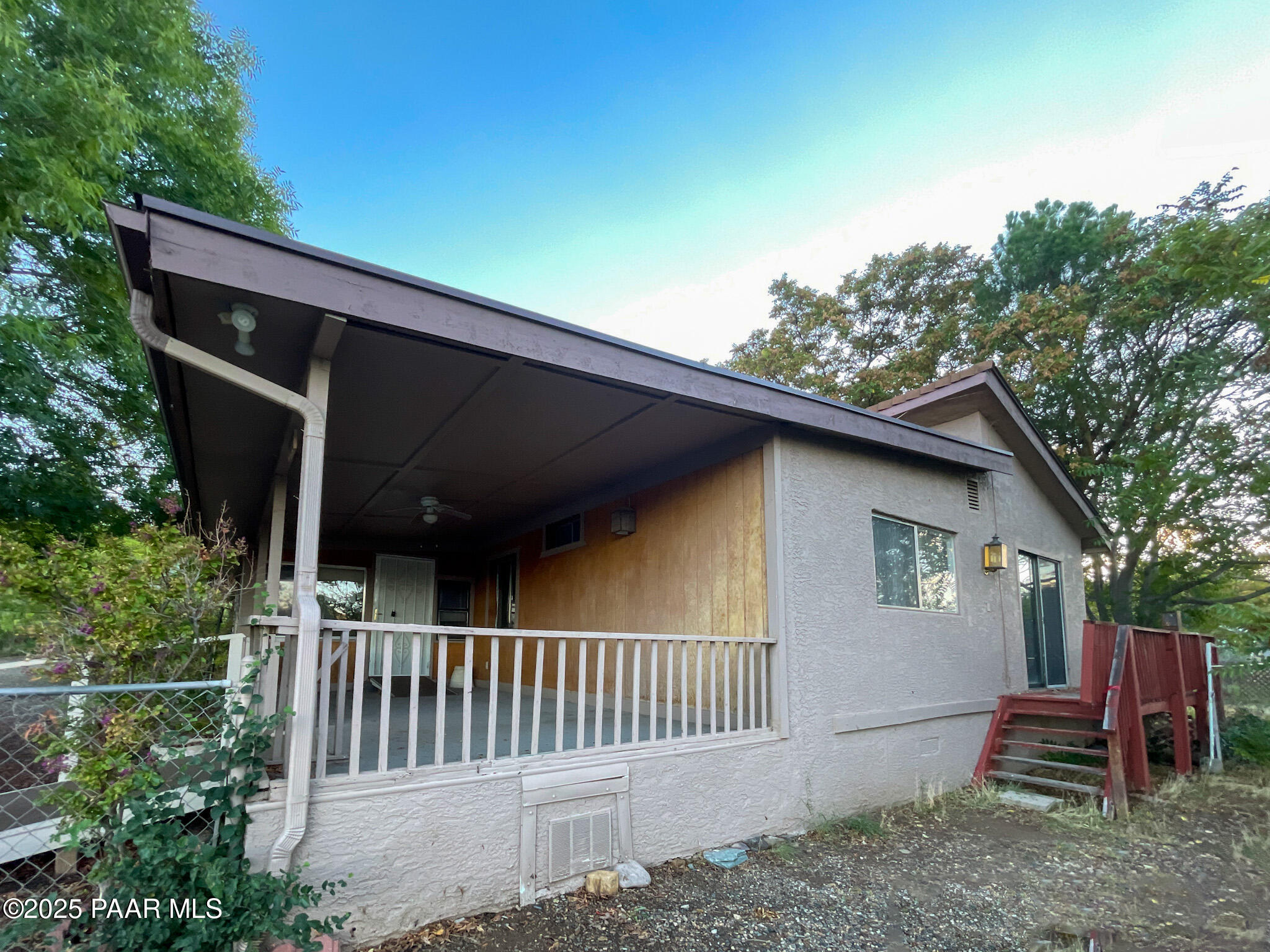 10198 Miami Street Mayer, AZ 86333 - Photo 26 of 29 a view of a wooden house with a yard and wooden fence