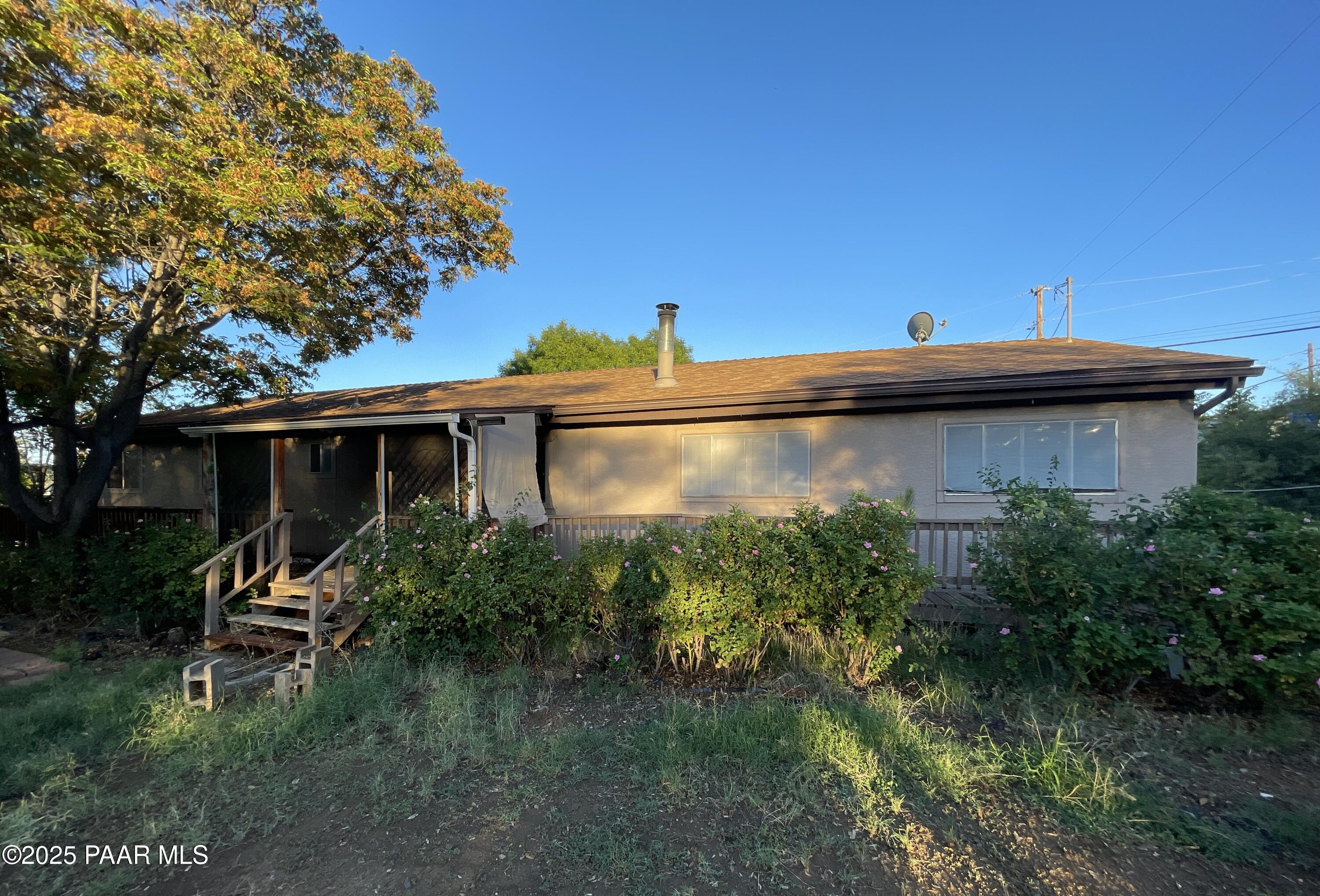 10198 Miami Street Mayer, AZ 86333 - Photo 29 of 29 a view of a house with a yard plants and large tree