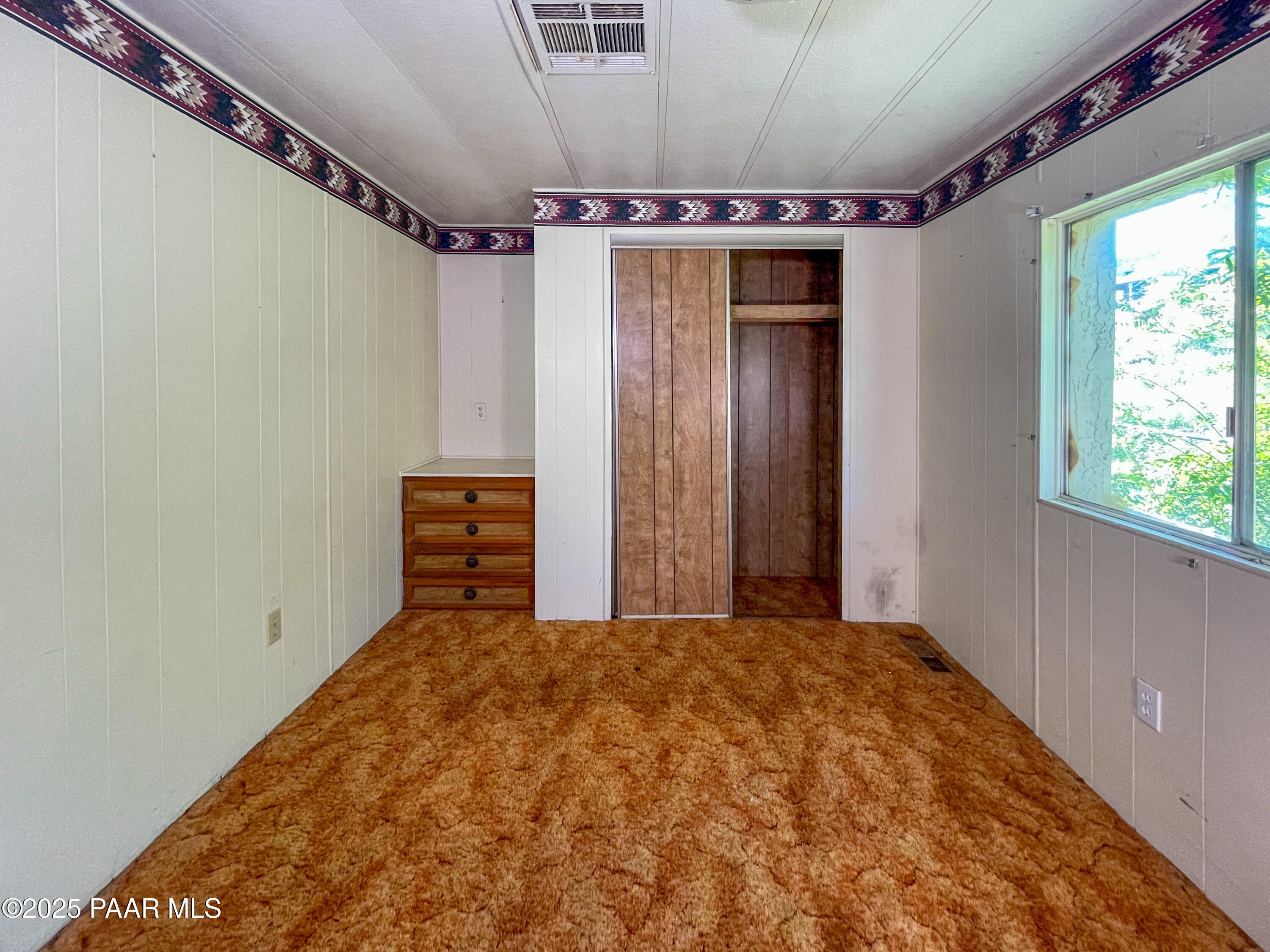 10198 Miami Street Mayer, AZ 86333 - Photo 8 of 29 a bed room with a bed and a window
