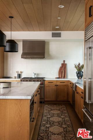 a kitchen with stainless steel appliances granite countertop a sink and a stove