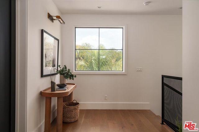 a room with a window and a potted plant