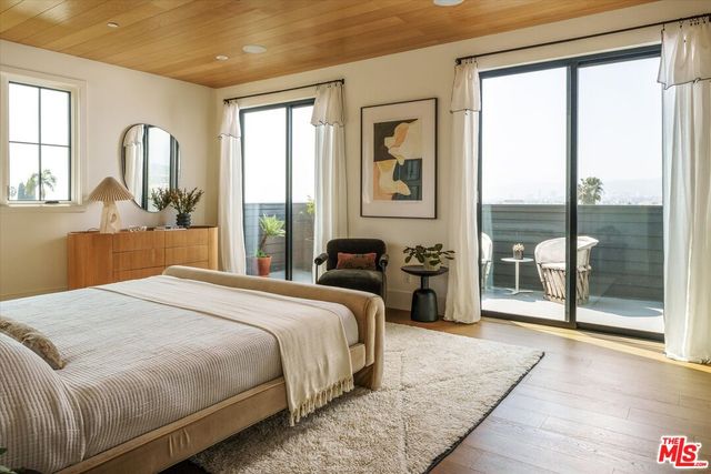 a bedroom with a large bed and a large window