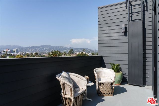 a balcony with table and chairs