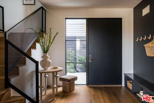 a view of entryway and hall with wooden floor