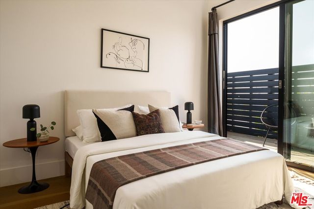 a bedroom with bed and a window