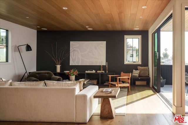 a living room with furniture a large window and a flat screen tv