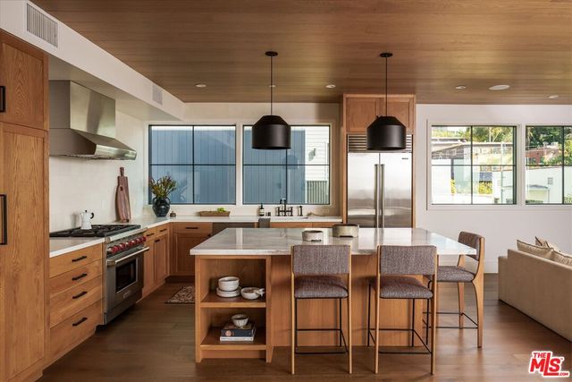 a kitchen with stainless steel appliances kitchen island granite countertop a sink and cabinets