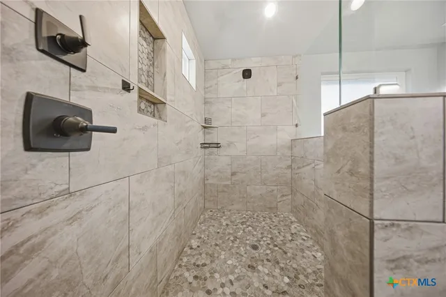 a bedroom with bed and a chandelier