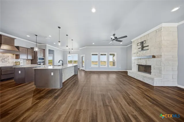 a view of a kitchen with a sink and a refrigerator