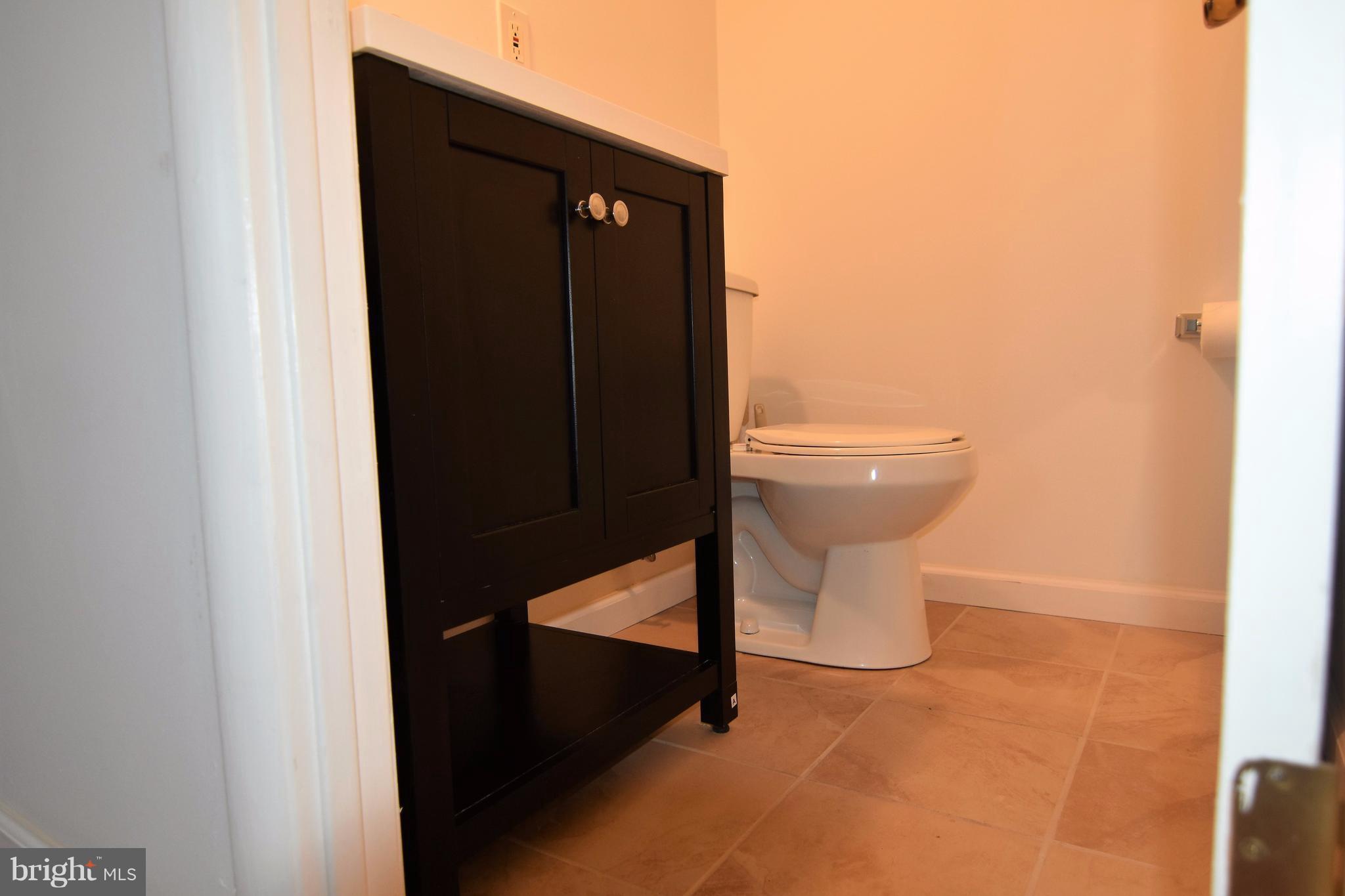 221 Dunlap Road Pasadena, MD 21122 - Photo 14 of 30 half bath in master bedroom w/ceramic tile