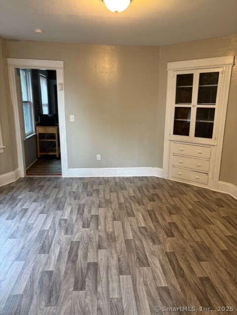 208 Fairview Avenue, Unit 2 Bridgeport, CT 06606 - Photo 2 of 11 a view of an empty room with wooden floor and a window
