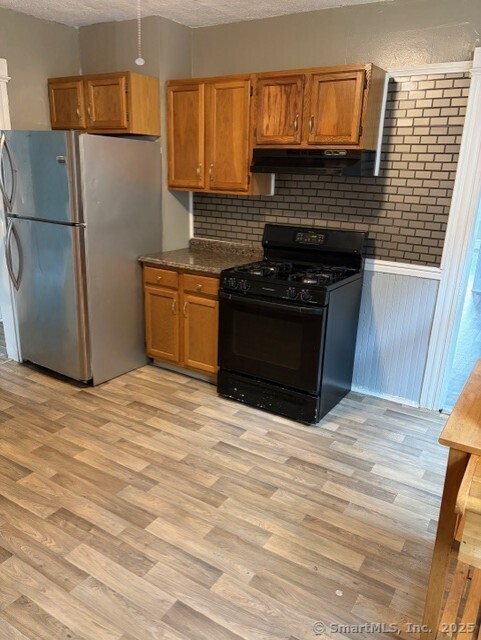208 Fairview Avenue, Unit 2 Bridgeport, CT 06606 - Photo 5 of 11 a kitchen with a refrigerator stove and cabinets