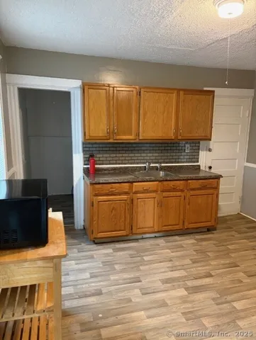 a kitchen with stainless steel appliances granite countertop a stove a sink and a microwave