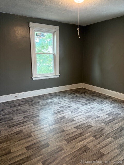 208 Fairview Avenue, Unit 2 Bridgeport, CT 06606 - Photo 9 of 11 wooden floor in an empty room
